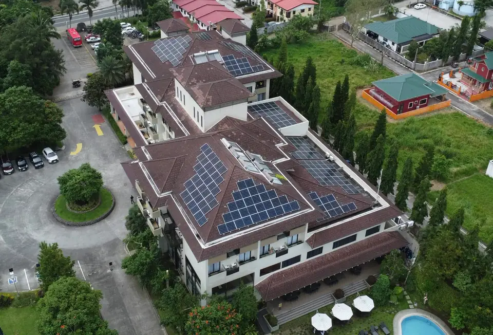 Aerial view of a commercial building with rooftop solar panels
